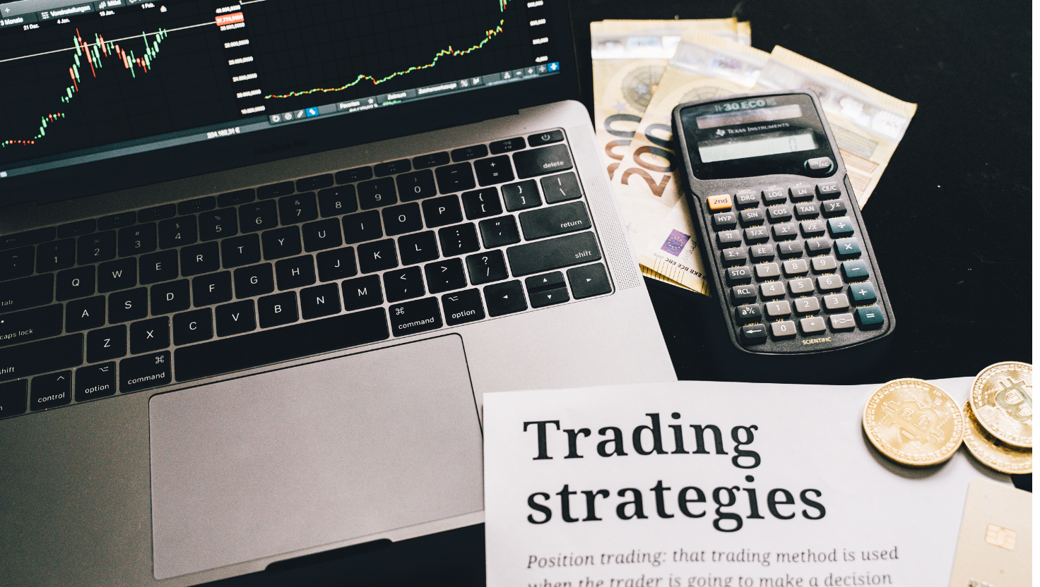 A person working on his laptop with trading strategies